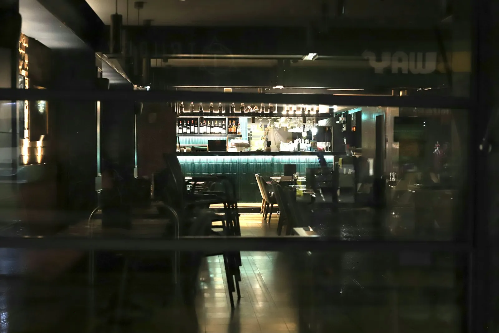 A lit bar counter glowing in a dark room